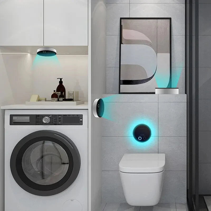 Bathroom with washing machine, toilet, and wall-mounted device with blue light